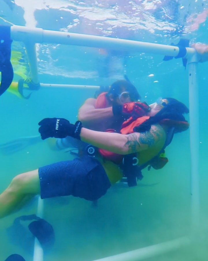 Two divers practising a rescue in the pool